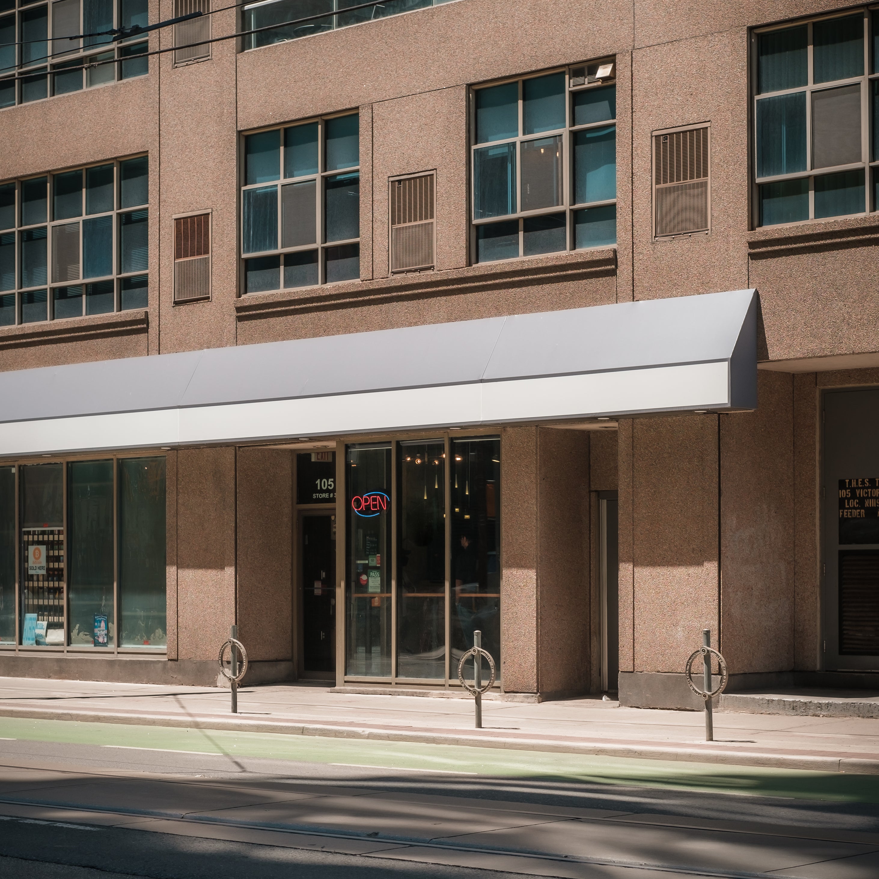 brown-building-lining-a-city-street.jpg